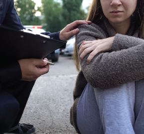 Human Trafficking: Officer helping victim.
